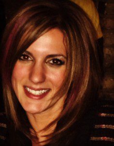 A woman with brown hair and pink highlights.