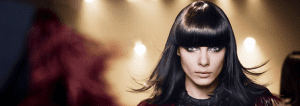 A woman with long black hair and bangs.